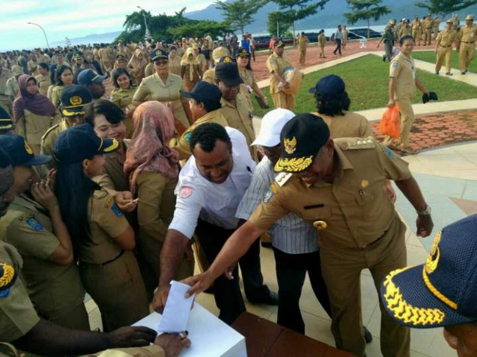 Gubernur Papua Barat Dominggus Mandacan mengisi kotak bantuan sukarela untuk warga Asmat dan warga pedalaman Papua Barat, Selasa (30/1).